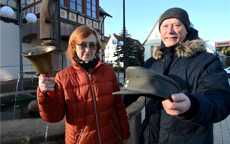 Eugen Scheurenbrands Nachkommen Jörg Scheurenbrand und Doris Süßer präsentieren die Mütze und Glocke ihres Vaters vor dem Rathaus. GB-Foto: Holom